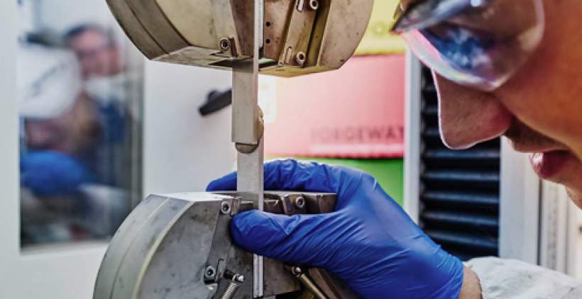 Technician testing adhesives in laboratory