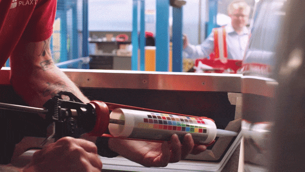 Applying coloured sealant to a bus