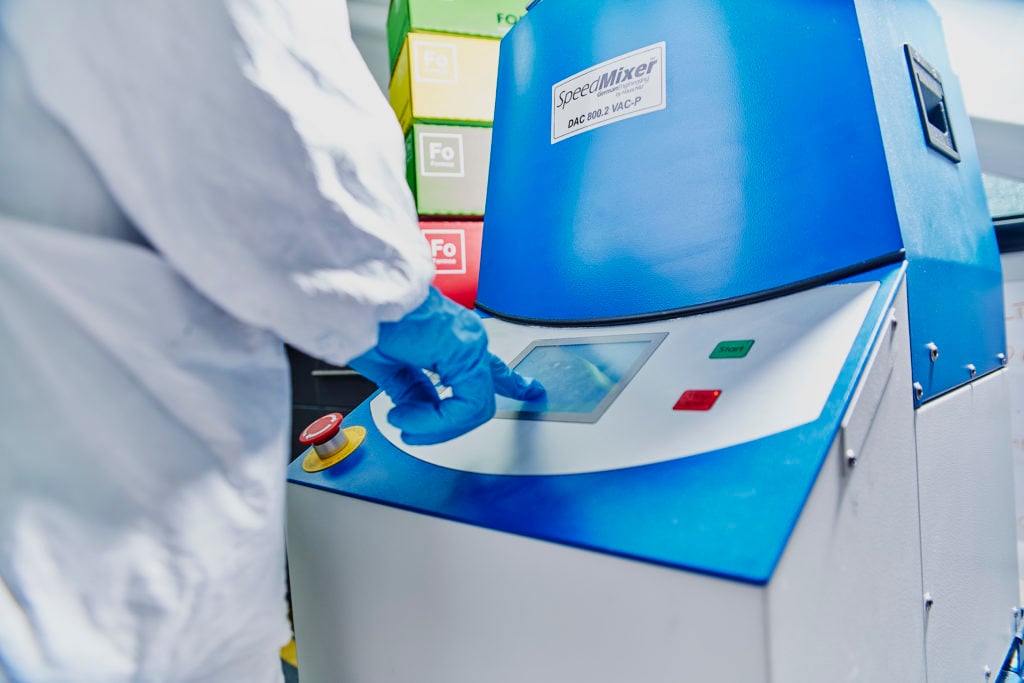 Technician using machinery to test the product
